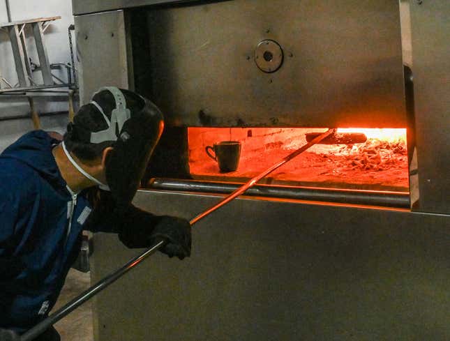 Image for article titled Mortician Reheats Mug Of Coffee In Corner Of Oven During First Cremation Of Day